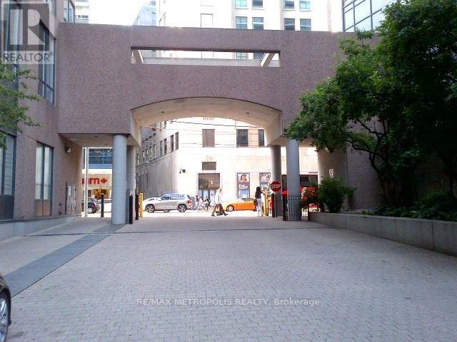 A building with a large archway entrance and a sign that says REALTOR.