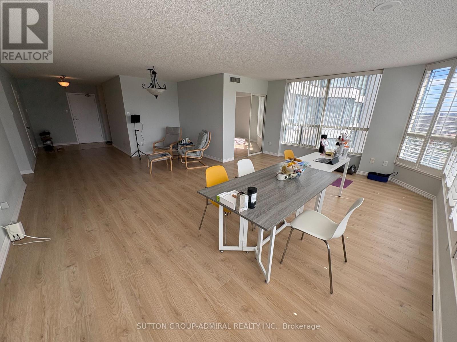 A dining room with a table and chairs.