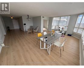 A dining room with a table and chairs.