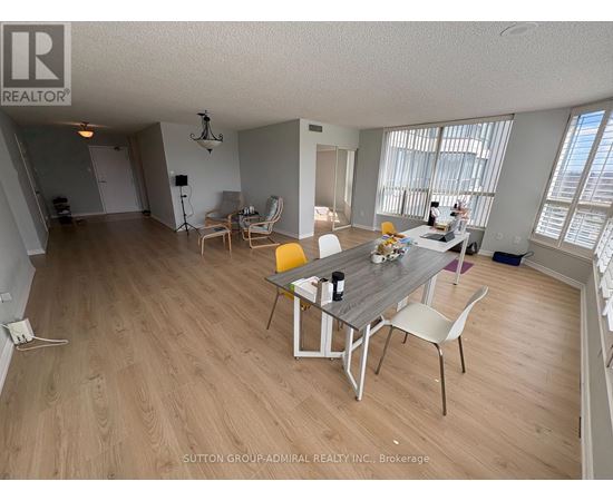 A dining room with a table and chairs.