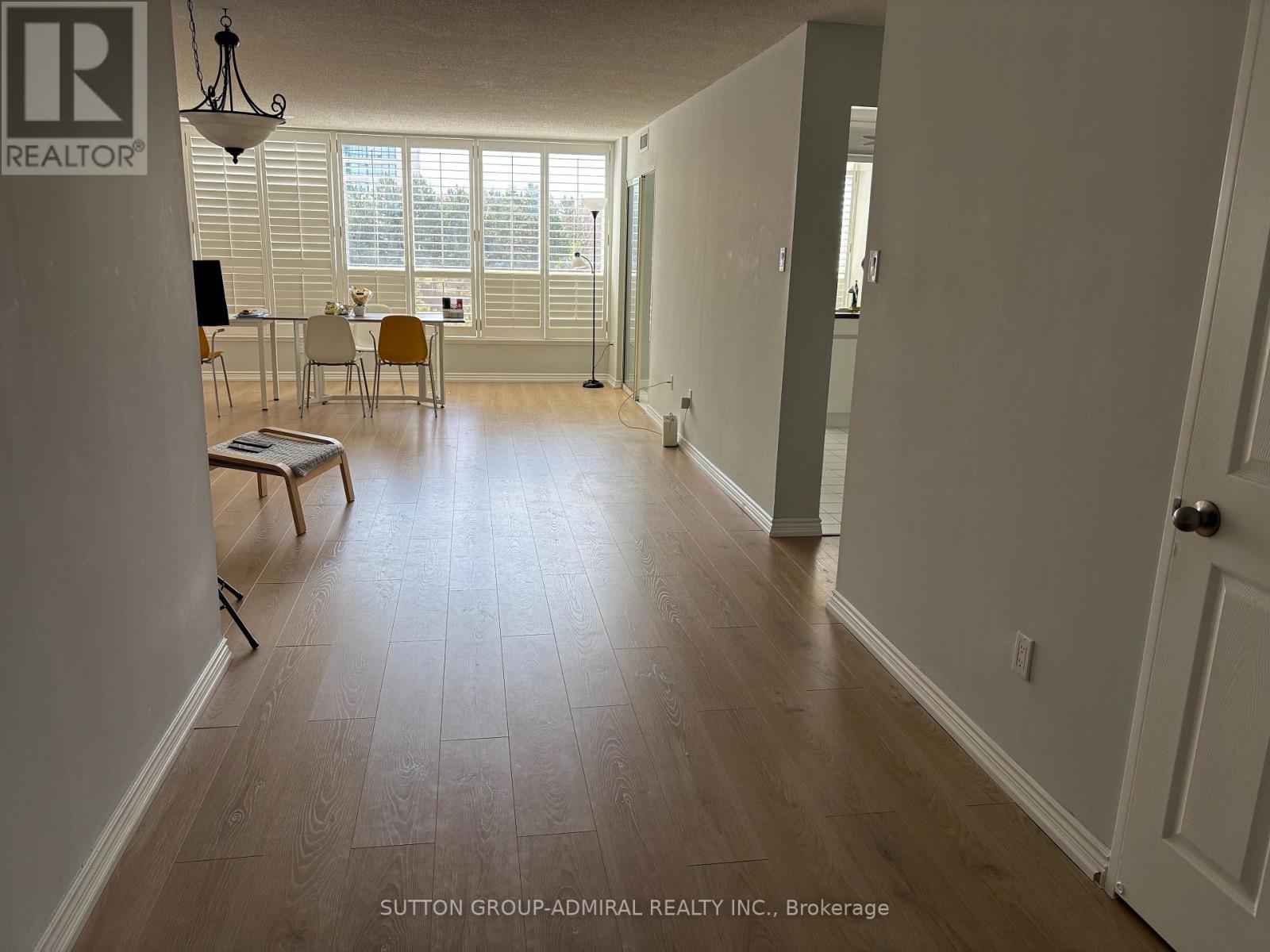 A room with a dining table and chairs in it.