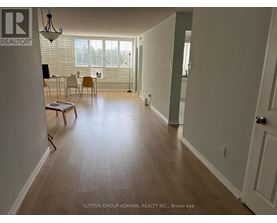 A room with a dining table and chairs in it.