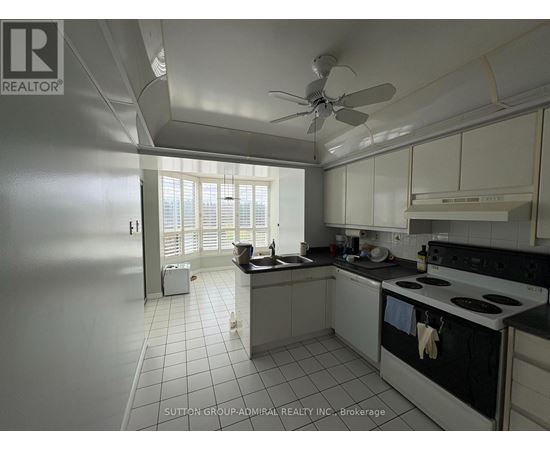 A kitchen with white cabinets and a black stove top oven.
