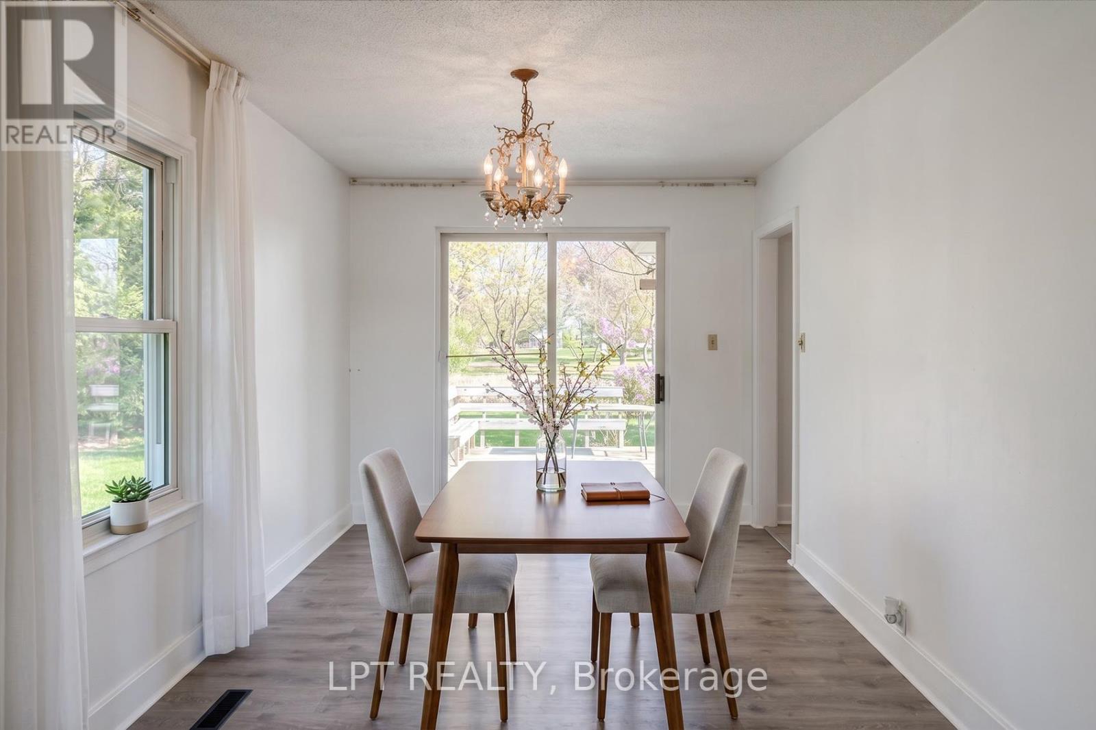 A dining room with a table set for four.