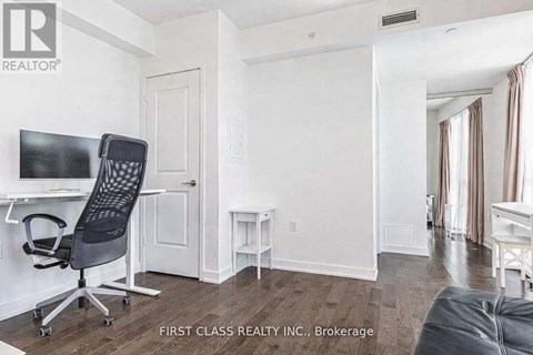 A room with a desk and a chair in it.