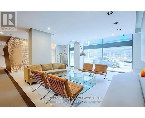 A modern living room with a glass table and a sofa.