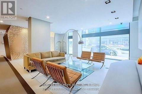 A modern living room with a glass table and a sofa.