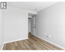 A room with a doorway leading to another room.