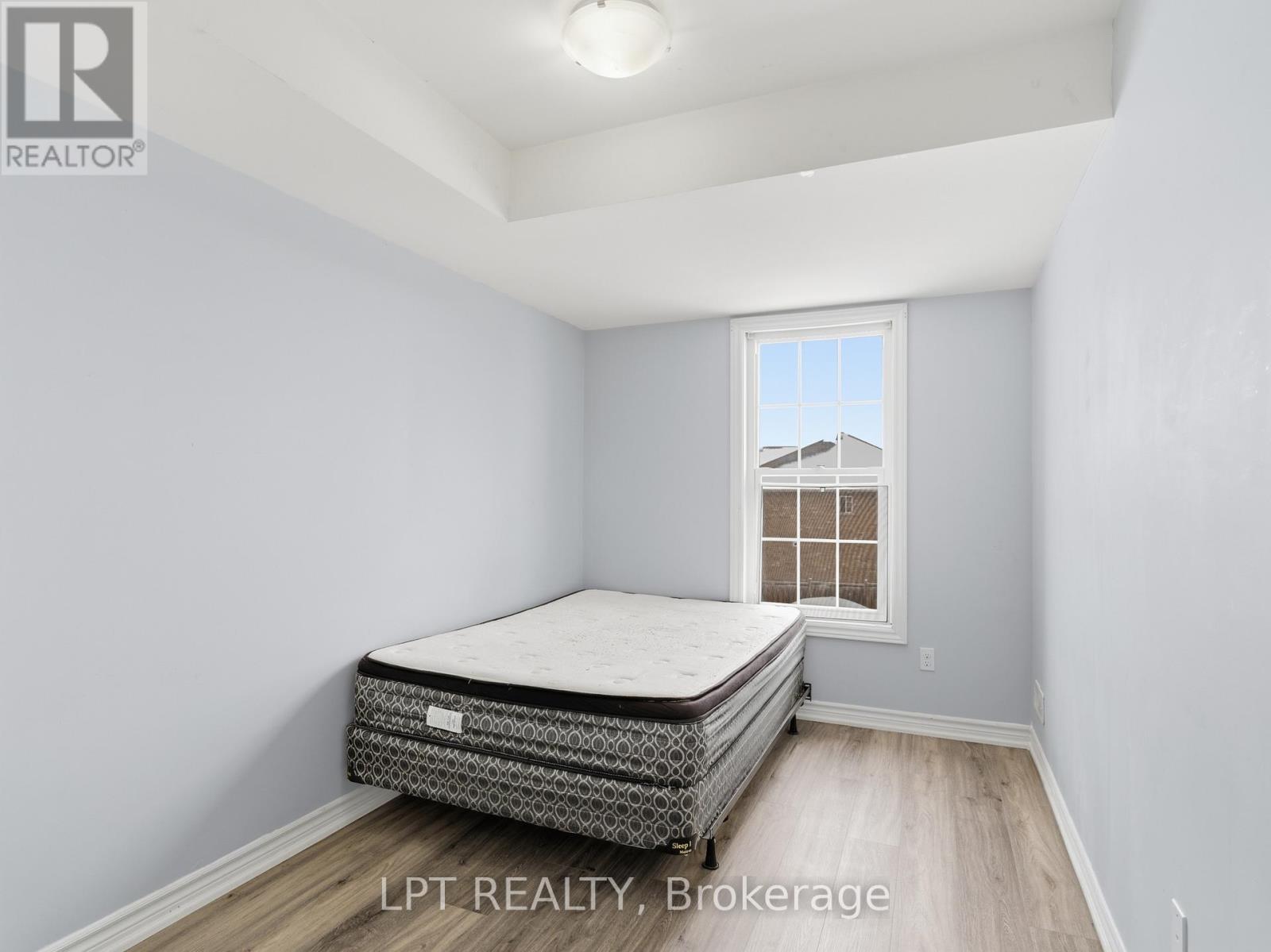 A bedroom with a bed and a window.