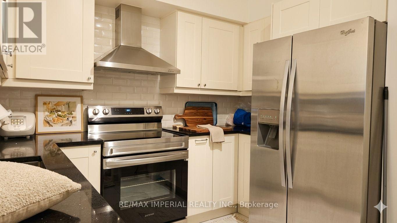A kitchen with a stainless steel refrigerator and oven.