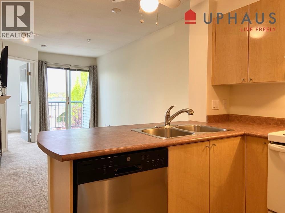 A kitchen with a sink and a dishwasher.