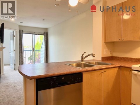 A kitchen with a sink and a dishwasher.