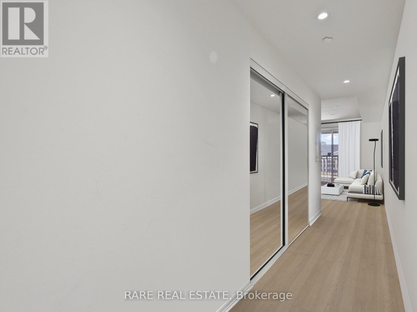 A spacious room with a sliding glass door leading to a balcony.