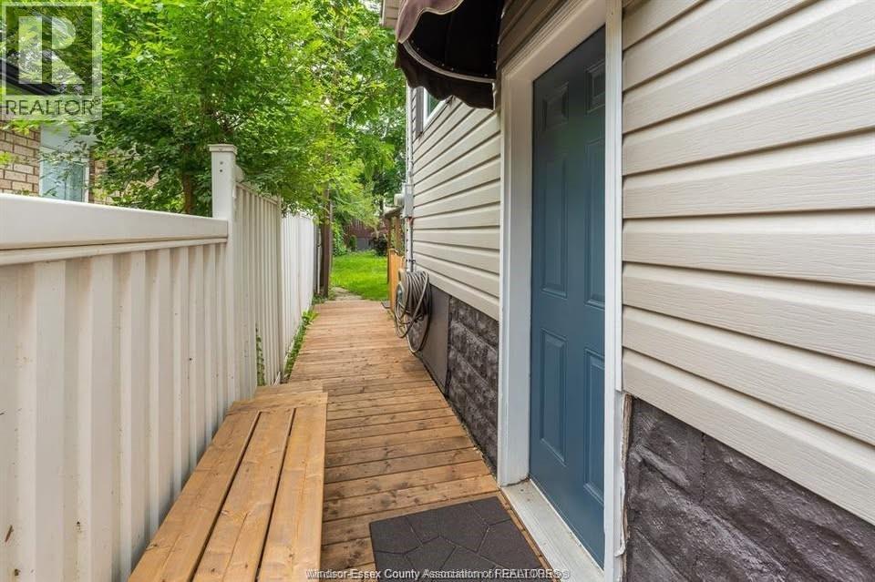 A house with a blue door and a wooden deck.
