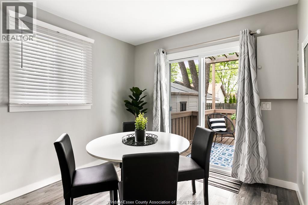 A dining room with a white table and chairs.