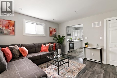 A living room with a grey couch and a coffee table.
