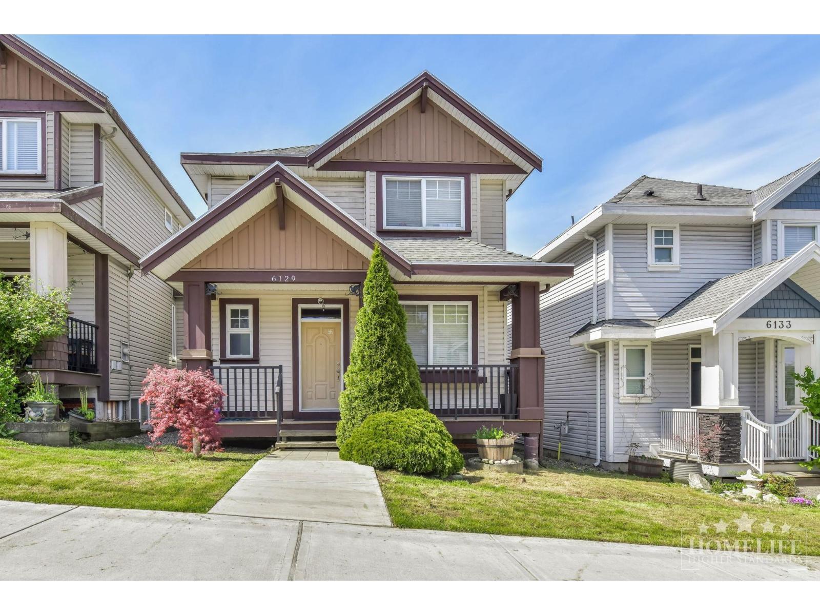 A house with the number 6133 on the front door is in the image.