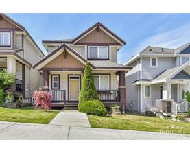 A house with the number 6133 on the front door is in the image.