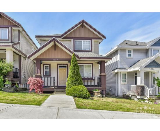 A house with the number 6133 on the front door is in the image.