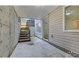 A concrete staircase leads to a balcony outside a home.