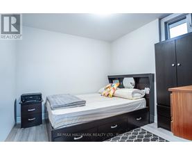 A bedroom with a bed, nightstand, and wardrobe.