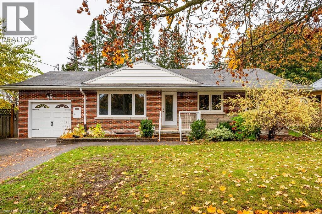 A house with a red brick exterior and a white garage door.