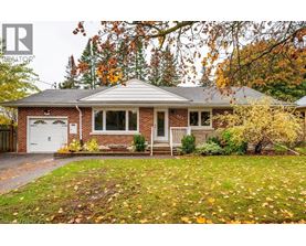 A house with a red brick exterior and a white garage door.