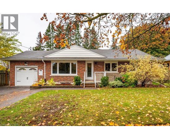 A house with a red brick exterior and a white garage door.