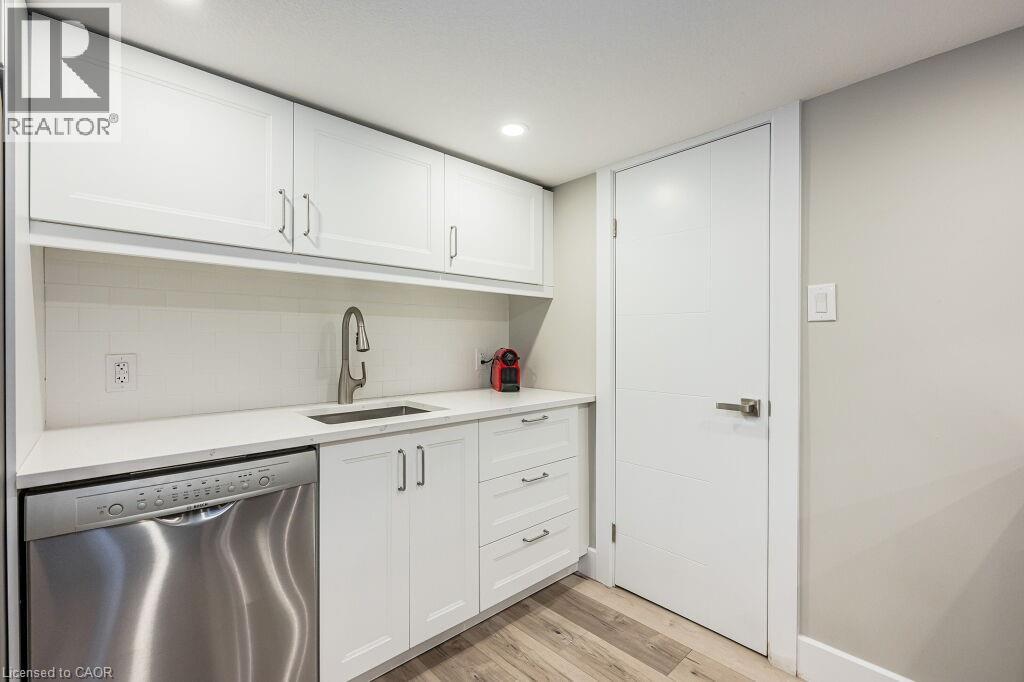 A kitchen with white cabinets and a stainless steel dishwasher.