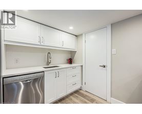 A kitchen with white cabinets and a stainless steel dishwasher.