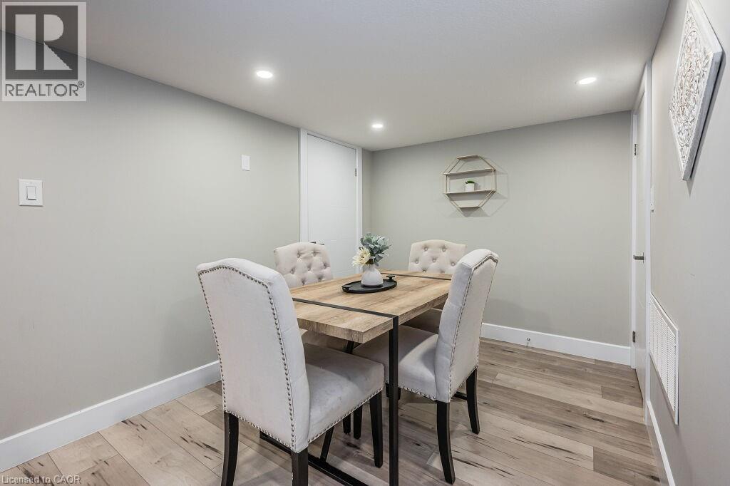 A dining room with a table and chairs.