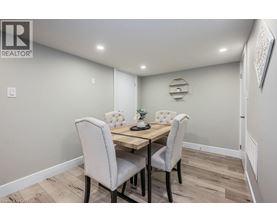 A dining room with a table and chairs.