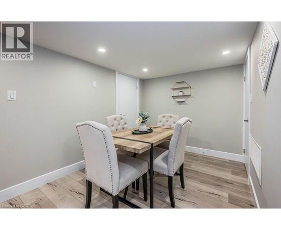 A dining room with a table and chairs.