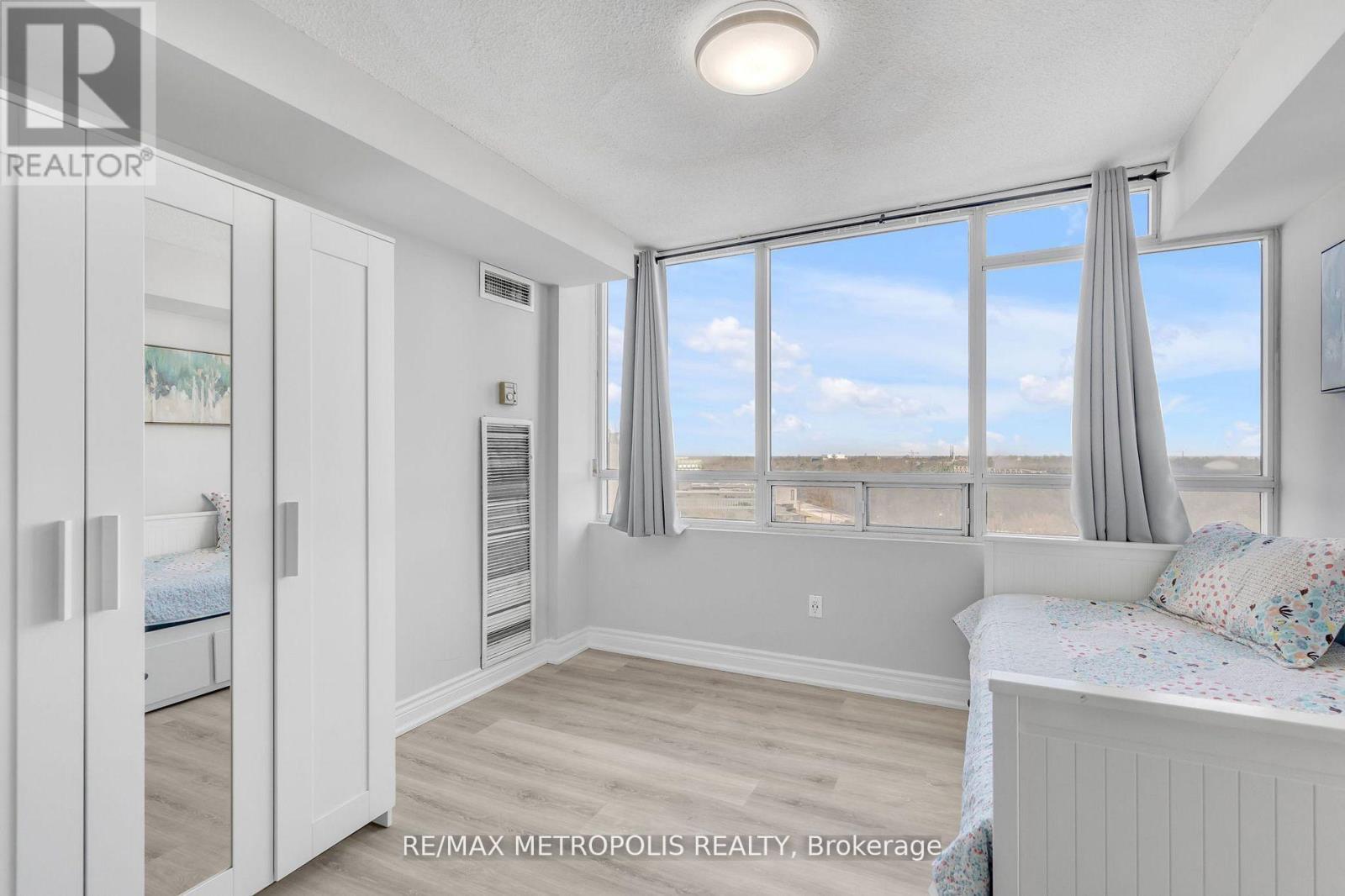 A bedroom with a large bed and a view of the beach.