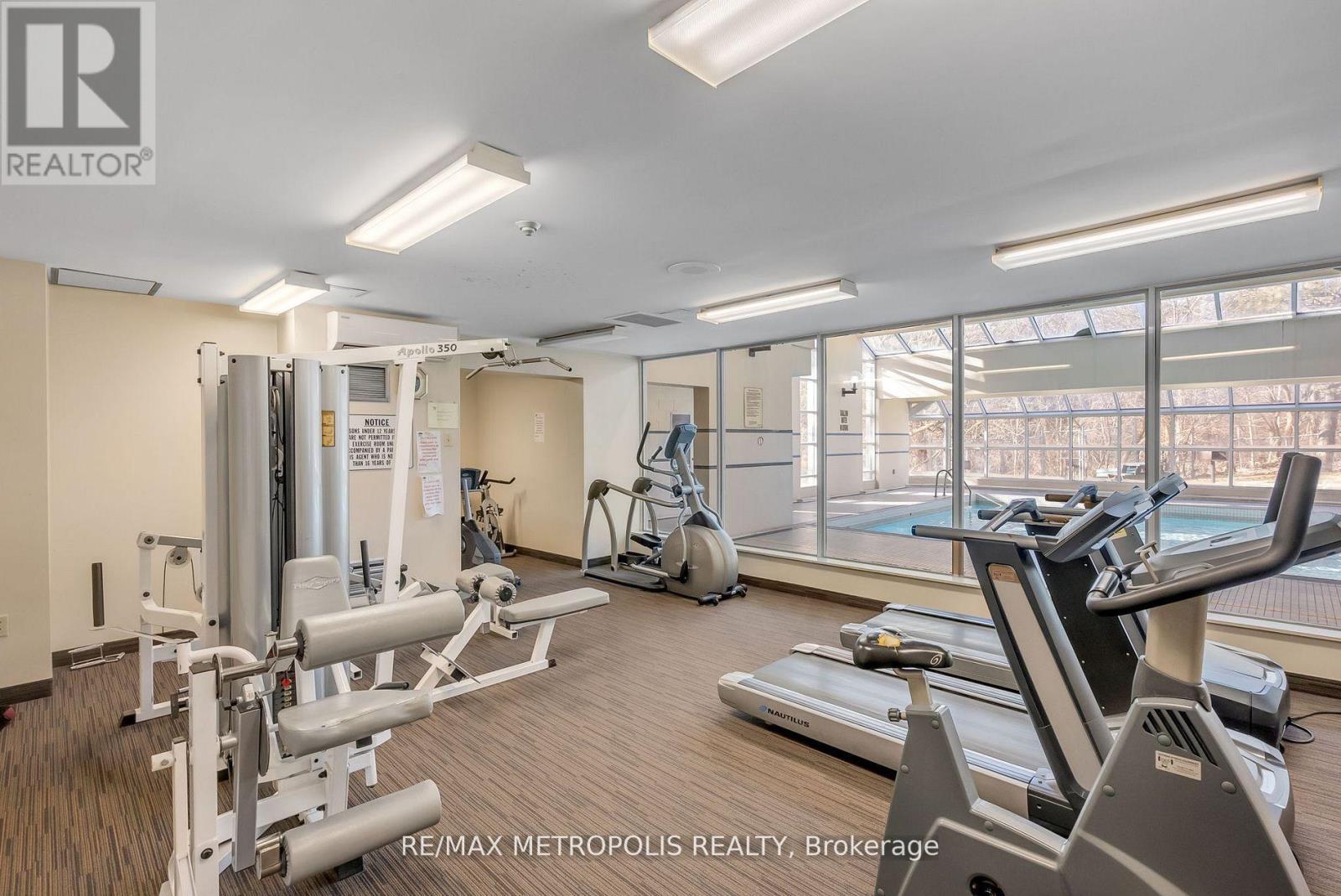 A gym with treadmills, elliptical machines, and other exercise equipment.