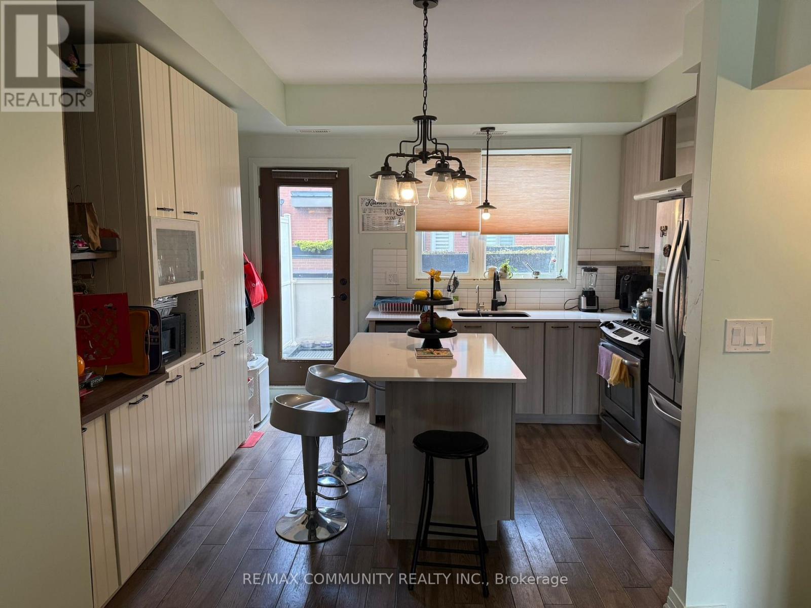 A kitchen with a table and chairs in the middle of it.