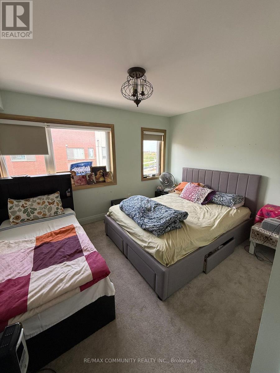 A bedroom with two beds and a window.