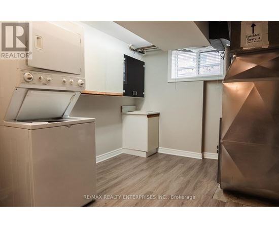 A small kitchen with a stove top oven and a microwave.