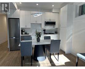 A modern kitchen with a dining table and chairs.