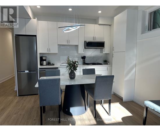 A modern kitchen with a dining table and chairs.