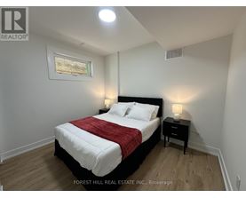 A bedroom with a bed, nightstands, and a painting on the wall.