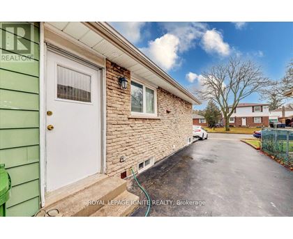 A house with a white door and a green wall.