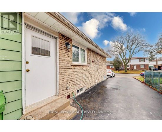 A house with a white door and a green wall.