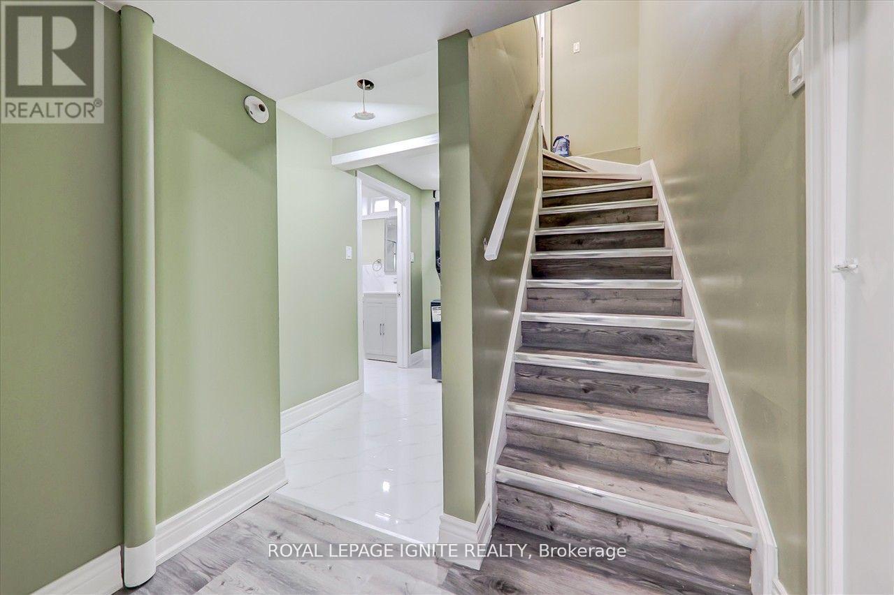 A staircase with wooden steps and a white railing.