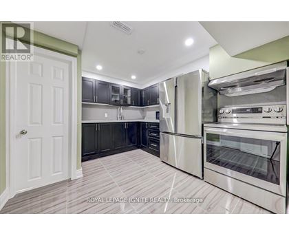 A kitchen with a white door and stainless steel appliances.