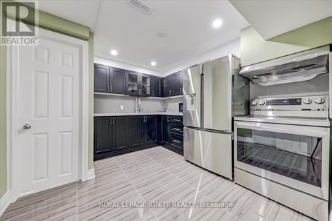 A kitchen with a white door and stainless steel appliances.