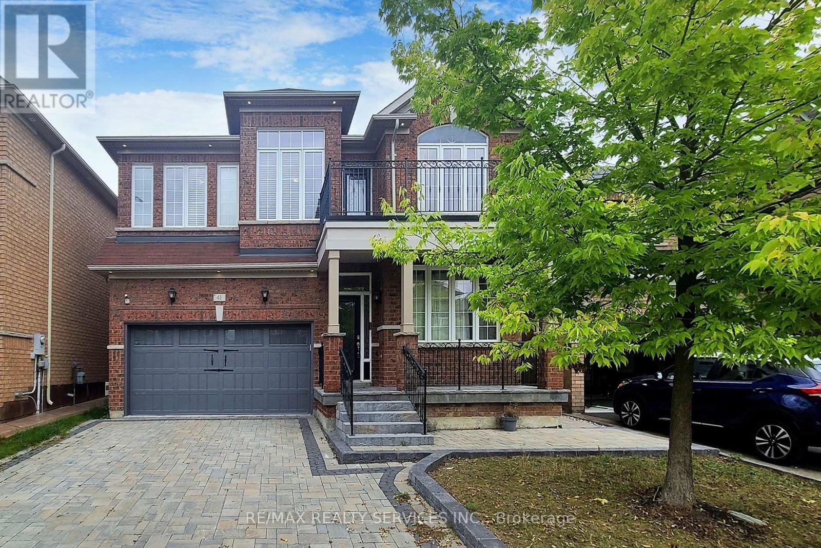 A house with a brick facade and a large front yard.