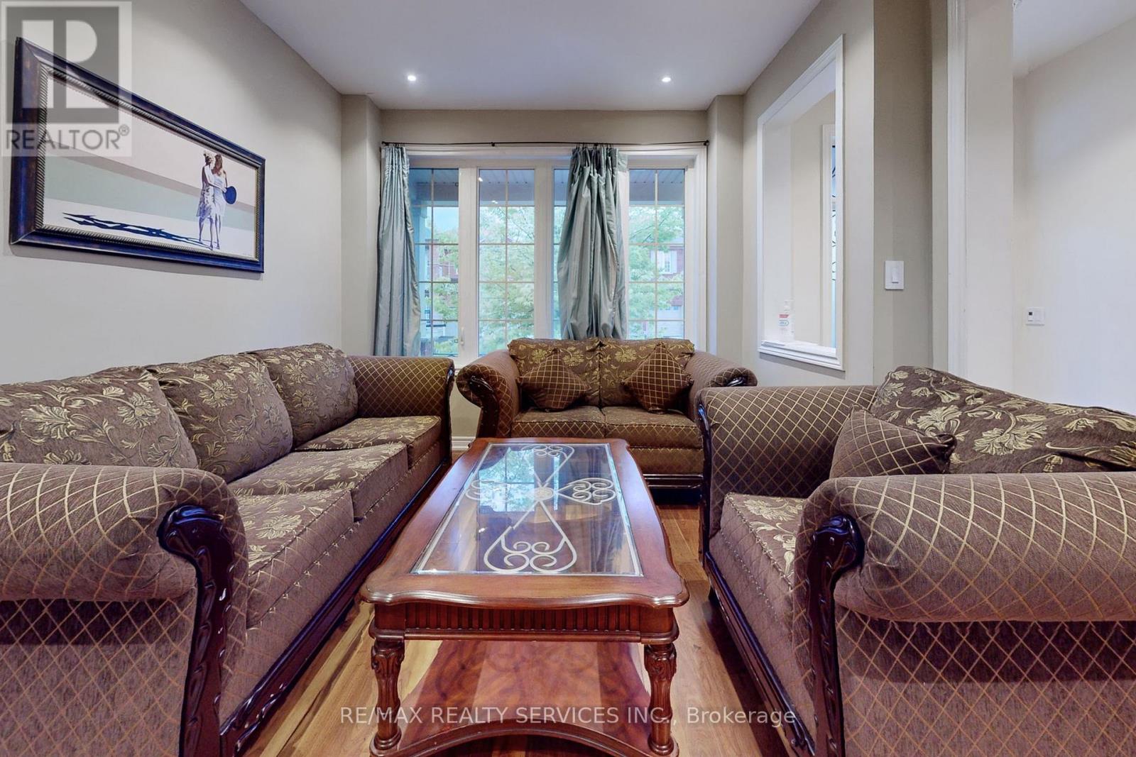 A living room with a brown coffee table and two sofas.
