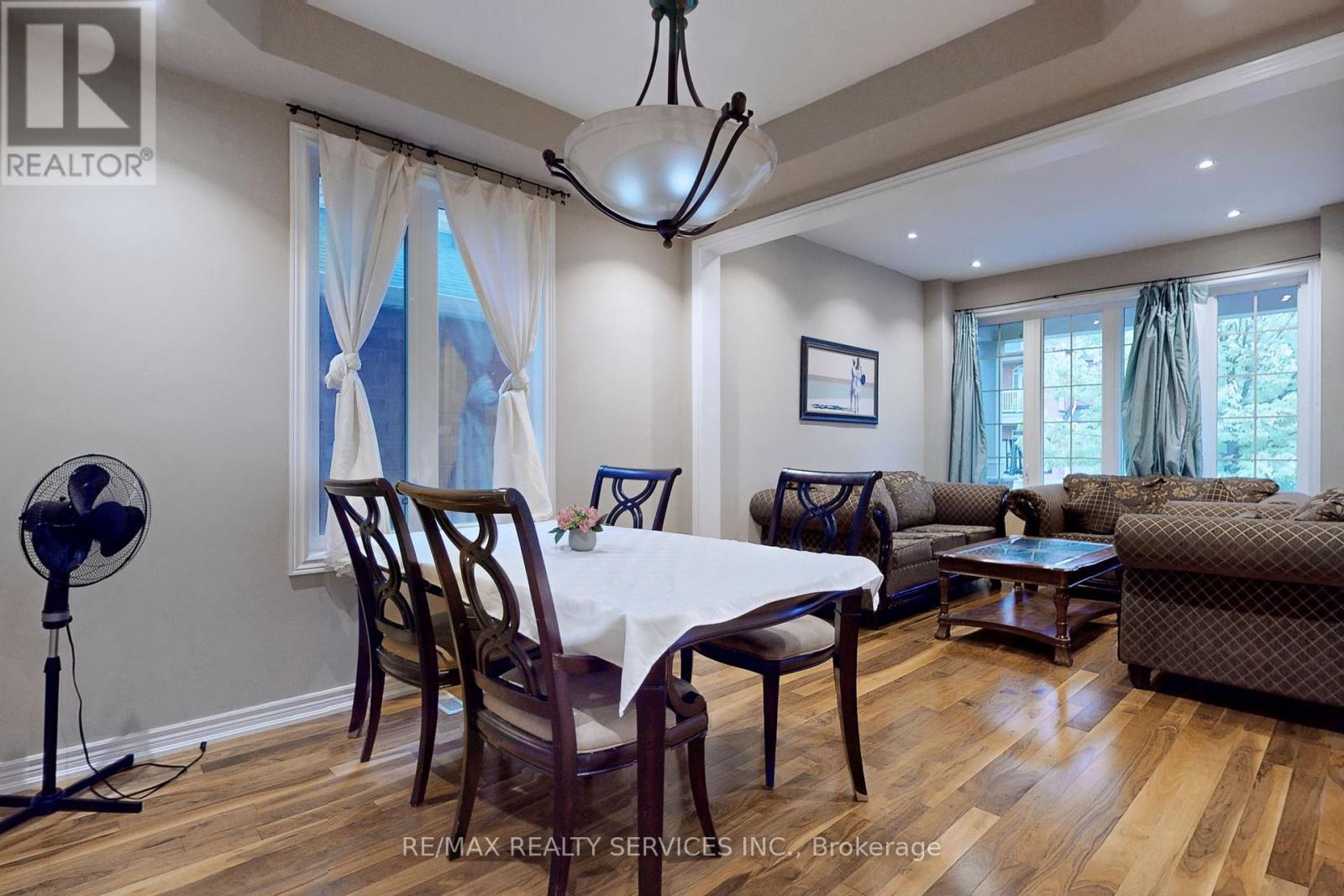 A dining room with a white table and chairs.