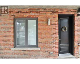 A brick wall with a door and a window.